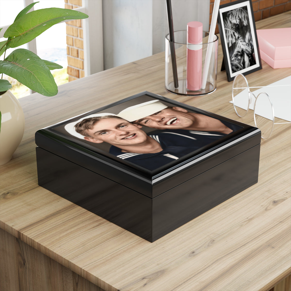 Angled glossy wooden keepsake box with a vintage photobooth portrait of two sailors in white caps, one smiling broadly.