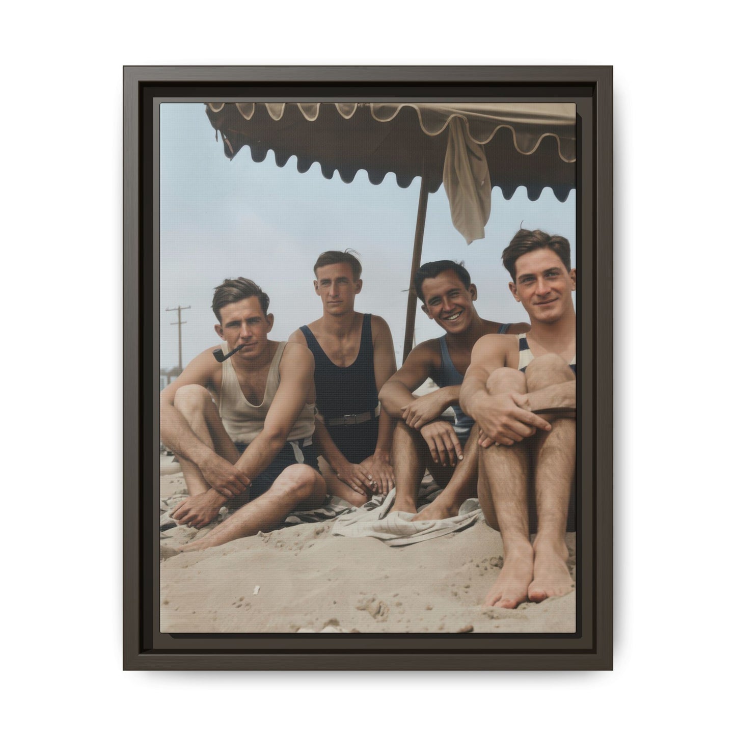 Historical seaside photograph reproduced as matte canvas with four figures seated on sand 