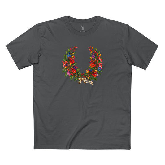 Dark T-shirt displaying an open ceibo floral wreath in Pride colors with white ORGULLO lettering centered below the botanical crown.