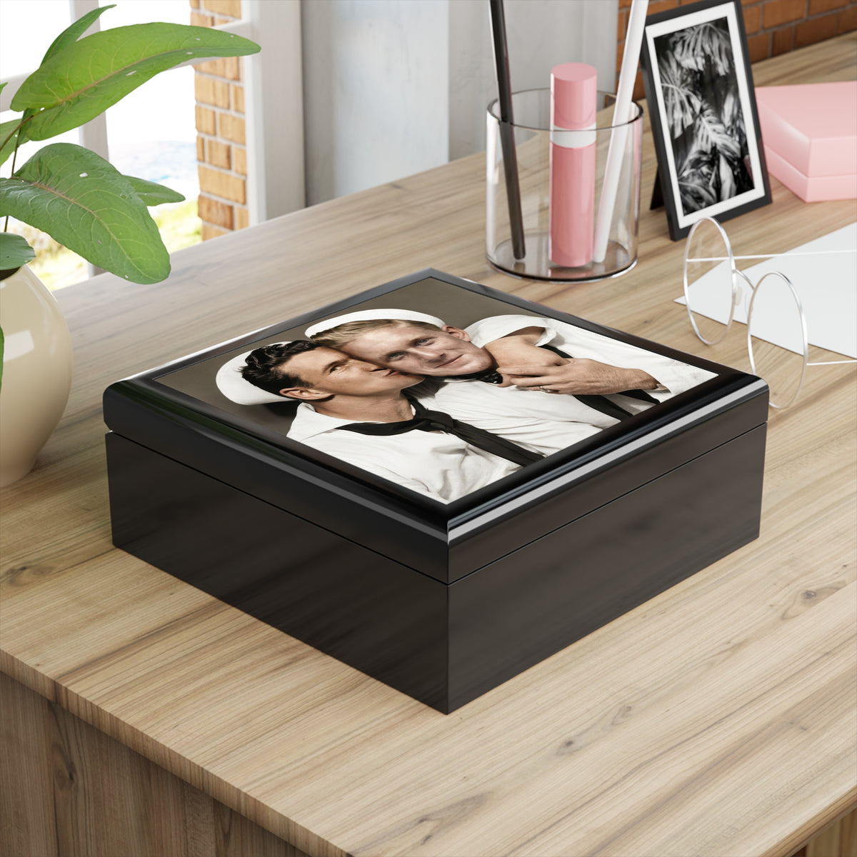 Angled glossy wooden keepsake box featuring two sailors in white uniforms, one leaning in to kiss the other’s cheek.