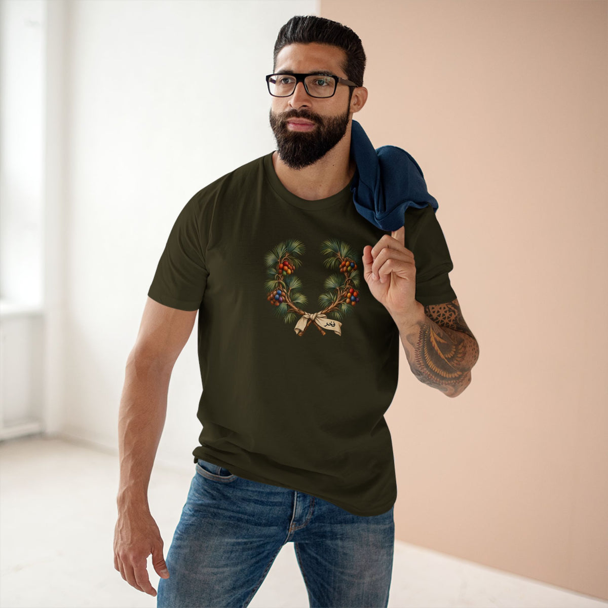 Model wearing a Sudanese doum palm Pride T-shirt with a vintage botanical wreath, fan-shaped foliage, and rainbow fruit clusters.