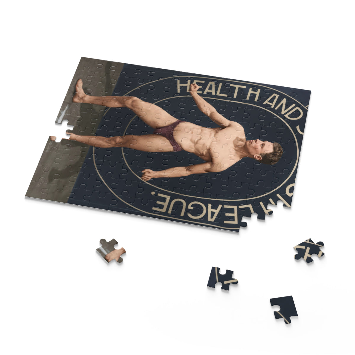 Close-up of physical culture photo jigsaw pieces showing cream backdrop lettering and an oval outline against navy.