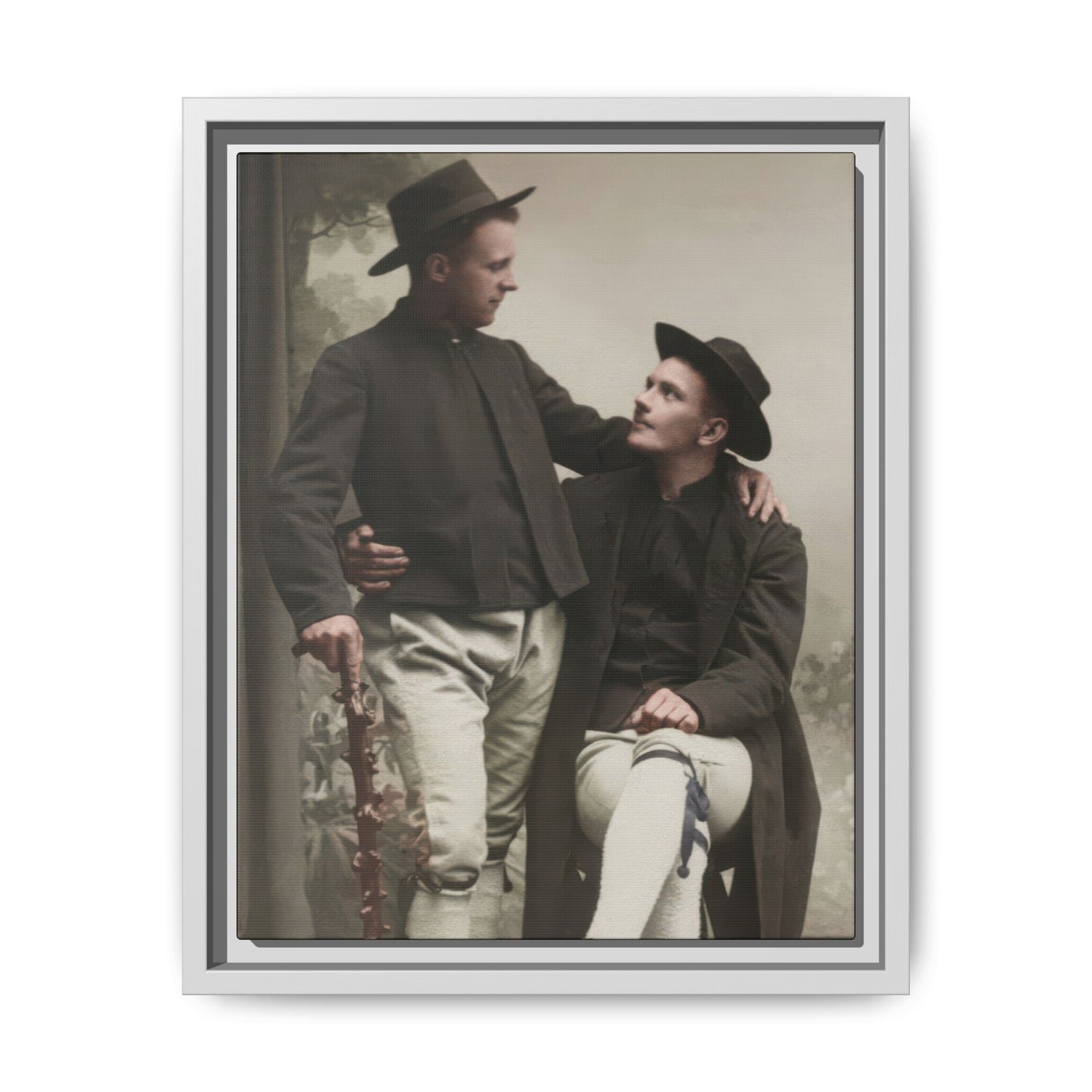 Early 20th century style paired portrait with one seated man and one standing man exchanging a direct gaze