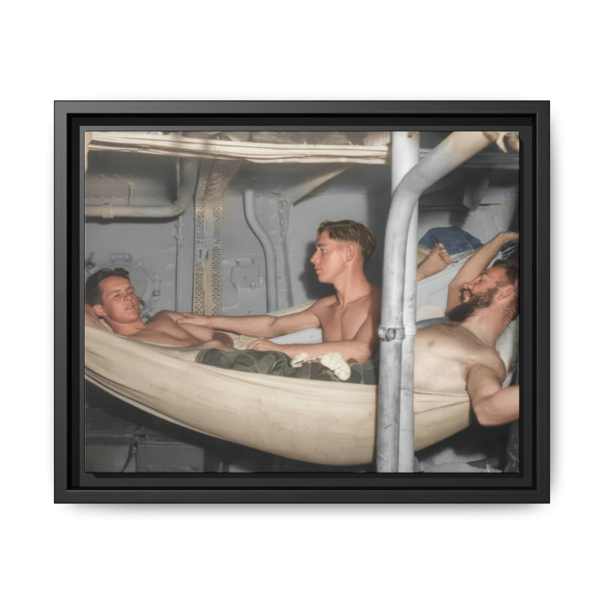 Restored historical photograph of three principal men among canvas hammocks, with exposed pipes and metal panels around them.