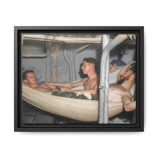 Restored historical photograph of three principal men among canvas hammocks, with exposed pipes and metal panels around them.