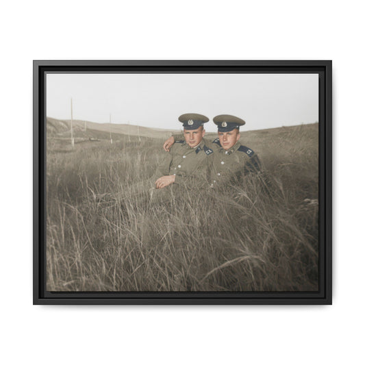 Historical double portrait showing two figures in matching uniforms and caps in an open field