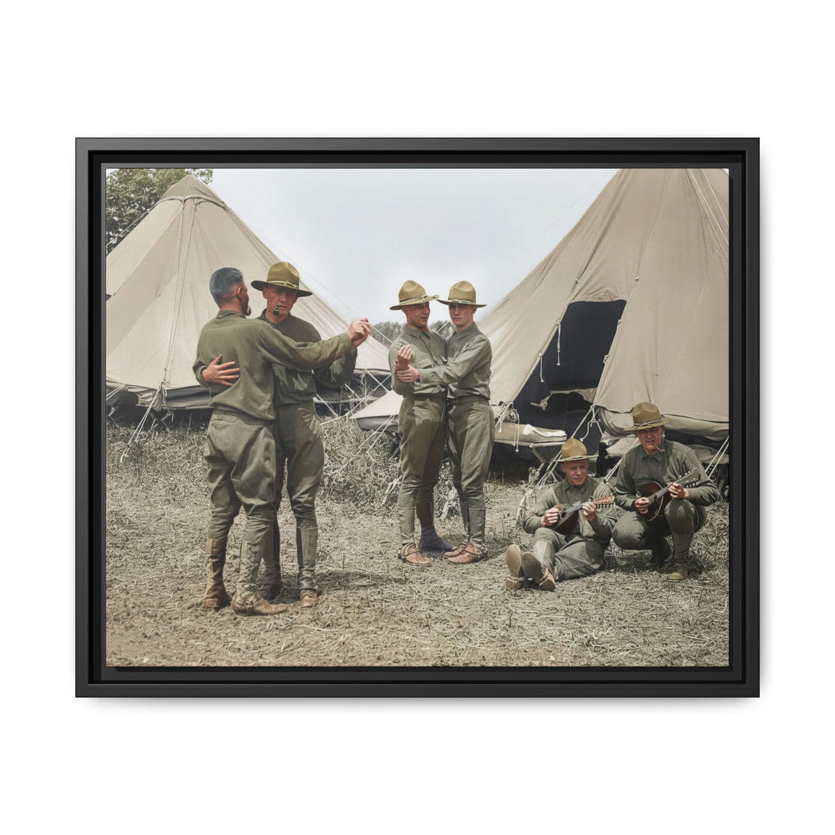 Hommes 006 framed matte canvas showing men in campaign hats dancing beside musicians at a tented military camp.
