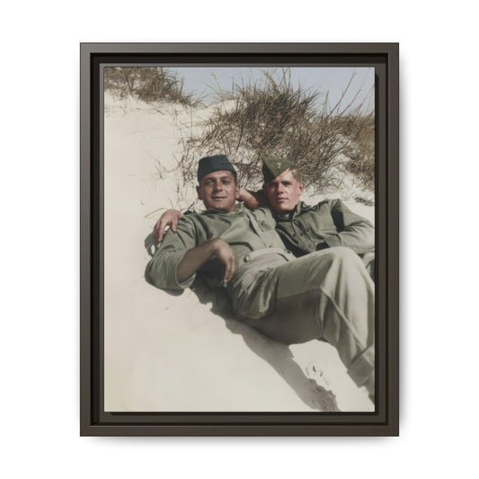 Historical military portrait showing two soldiers in side caps resting closely in a sandy outdoor landscape