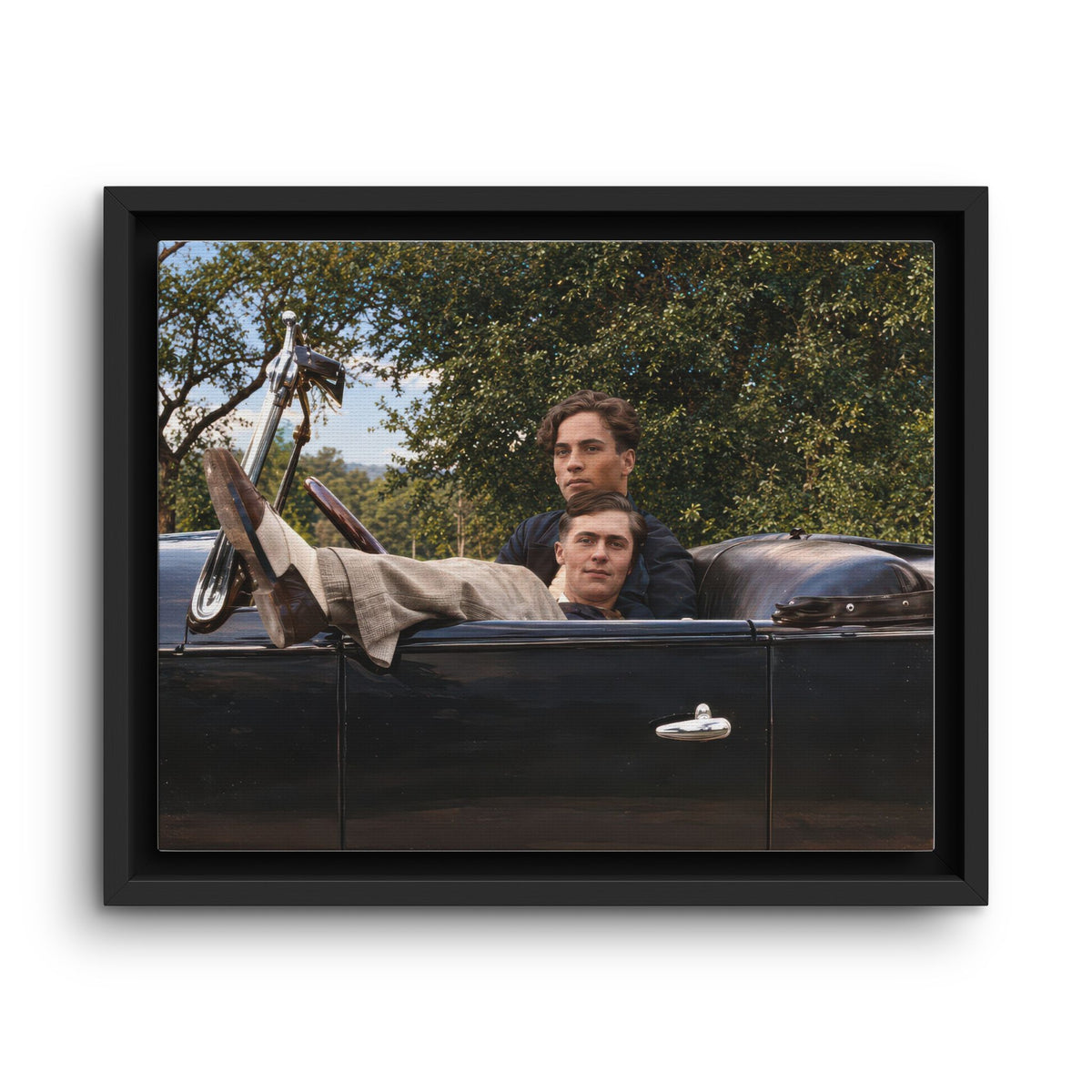 Two men seated in an open-top vintage automobile surrounded by trees, Paire-164 framed canvas artwork.