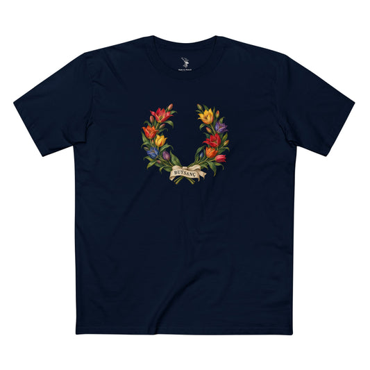 Open wild tulip wreath with red, orange, yellow, pink, blue, and violet blossoms, green leaves, and an ivory ribbon bearing BUÝSANÇ in charcoal serif lettering.