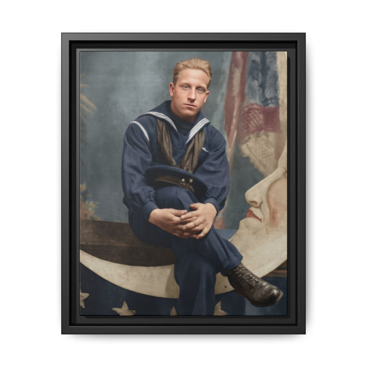 Restored vintage portrait of a man in sailor clothing seated on a crescent-shaped paper moon prop, with painted stars below.