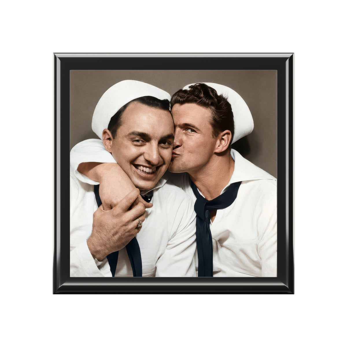 Closed varnished rubberwood keepsake box with ceramic tile lid showing two sailors, one kissing the other’s cheek.