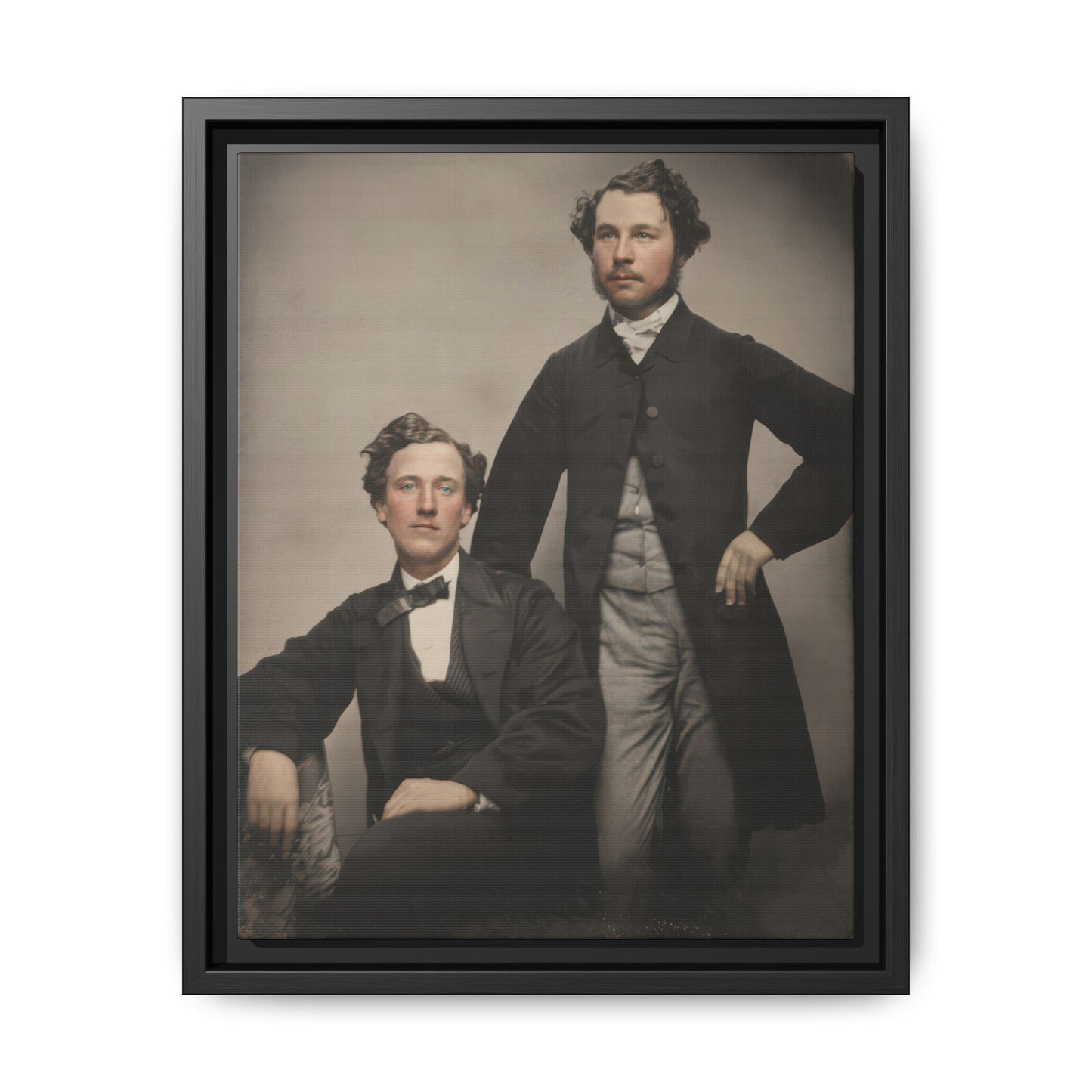 Vintage studio photograph of two formally dressed companions in a 19th century portrait