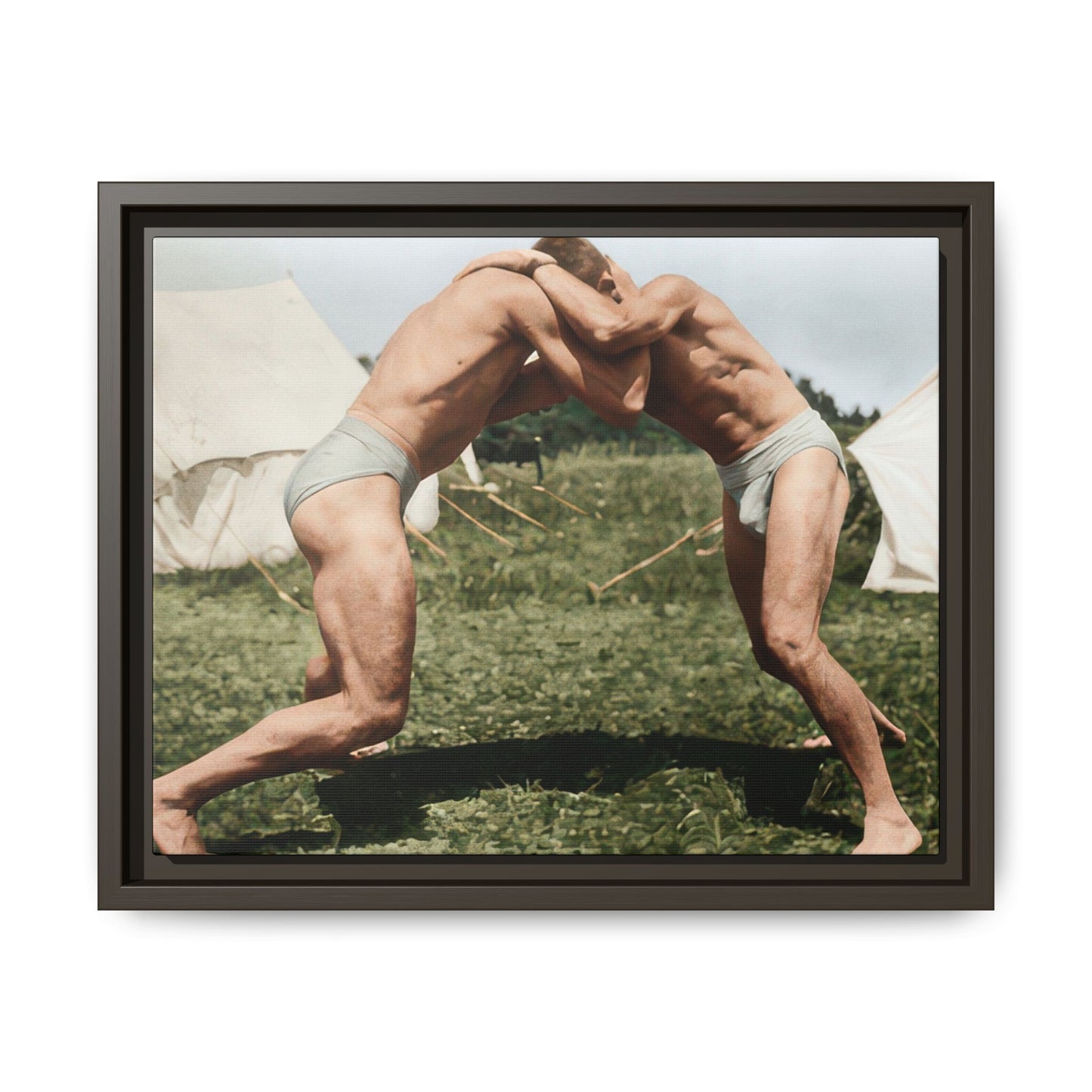 Two barefoot wrestlers in athletic trunks practicing an outdoor standing clinch 