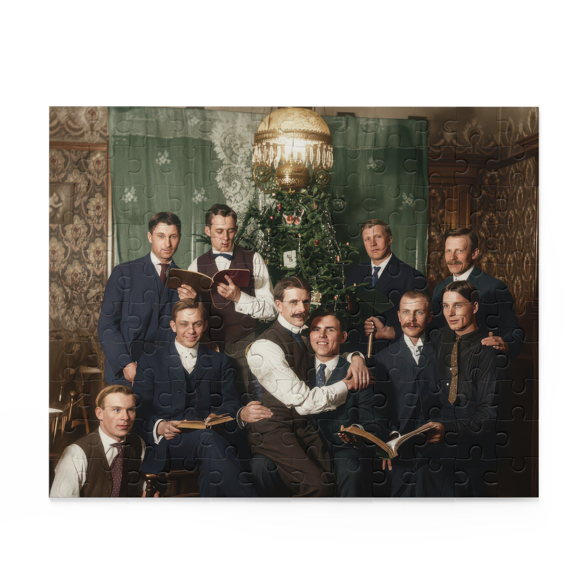 Artwork for a vintage Christmas jigsaw puzzle showing ten men with books gathered beside an ornamented tree beneath an ornate hanging lamp.