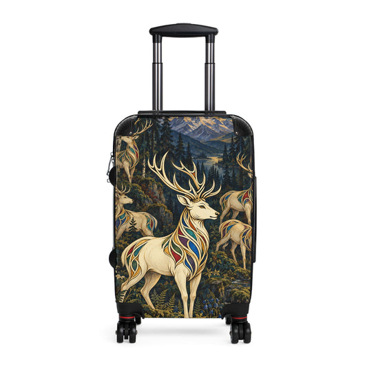The Jeweled Herd carry-on suitcase featuring five white stags with jewel-toned ornament in a moonlit mountain forest