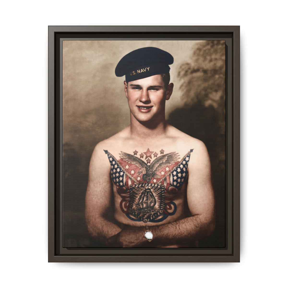 Sailor with a slight smile and an extensive chest tattoo depicting an eagle, American flags, stars, and a sailing ship.