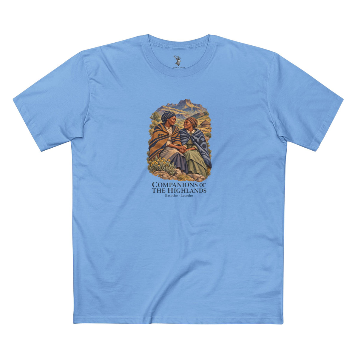 Dark T-shirt featuring two women in patterned blankets against a mountain landscape, with ivory Companions of the Highlands and Basotho · Lesotho lettering.
