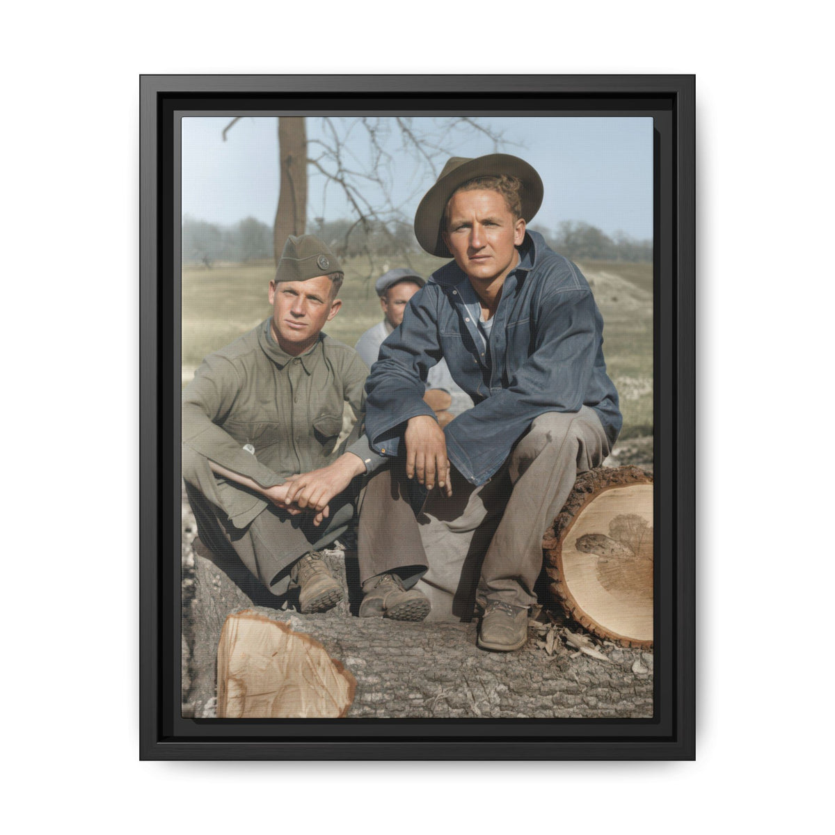 Restored colorized portrait of two men seated among cut logs, with a third man partly visible behind them in a rural landscape.