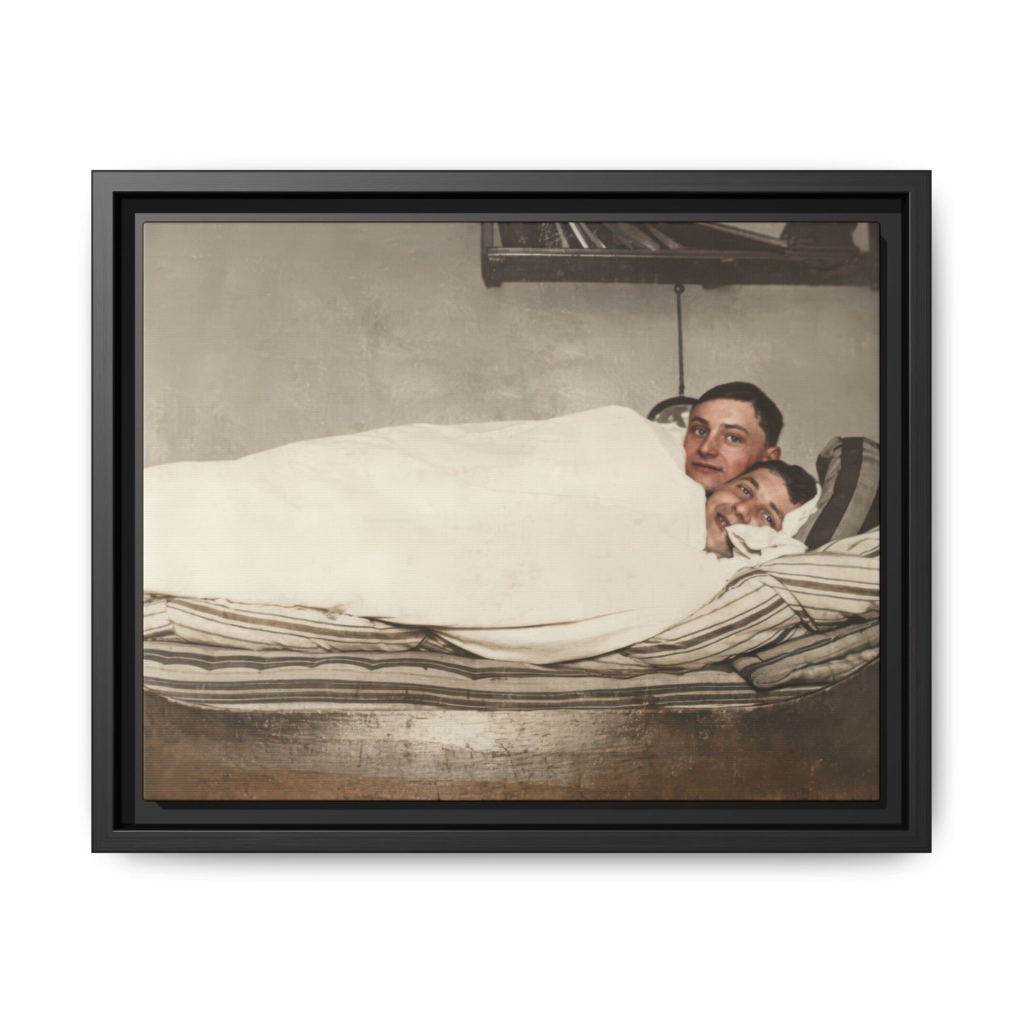 Vintage photograph of two figures reclining in bed under blanket interior scene