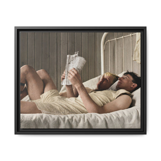 Historical domestic photograph showing two young men resting side by side in a wood-paneled bedroom with a tall window.