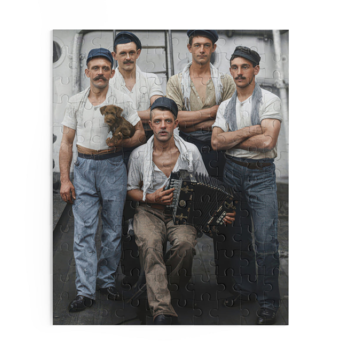 Artwork for an accordion jigsaw puzzle showing five men on a ship’s deck, one seated with an accordion and another holding a small brown dog.