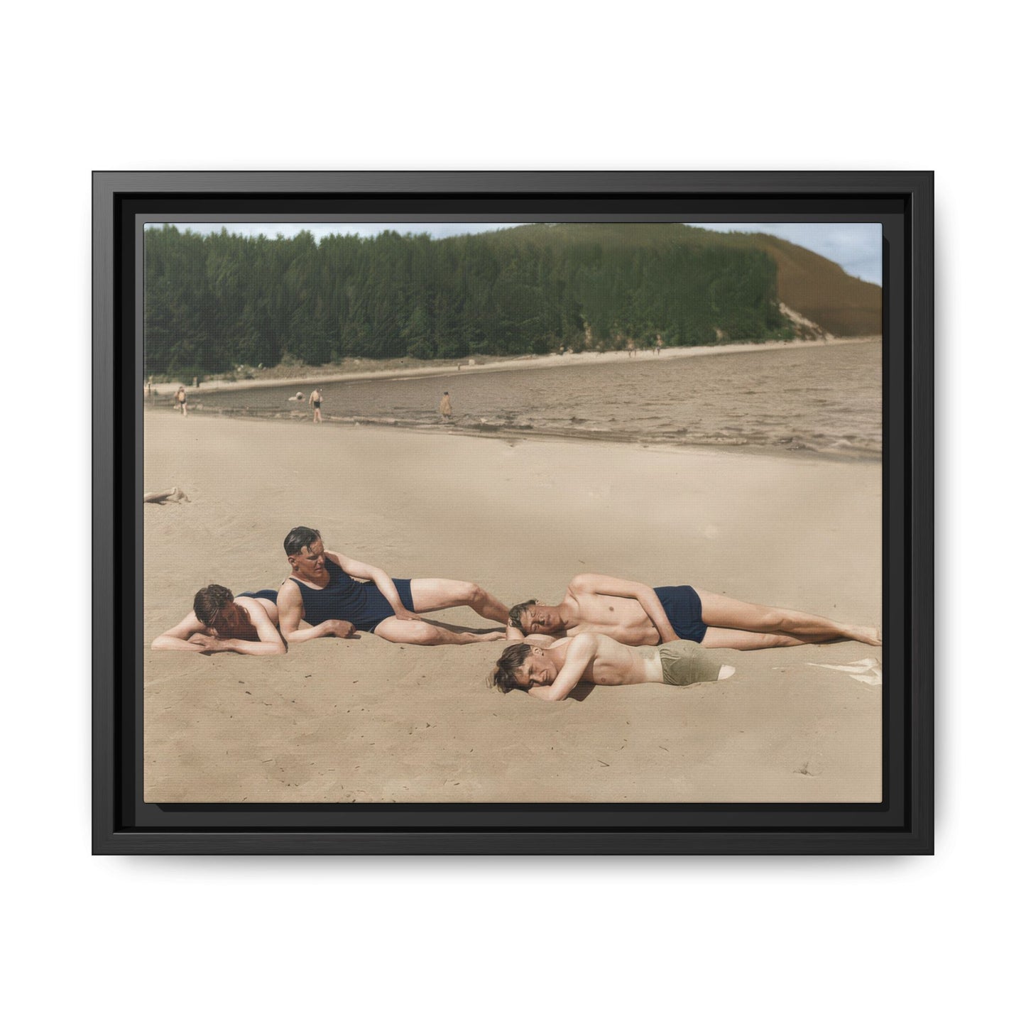 Framed vintage canvas wall art showing four bathers reclining on a lakeside beach 