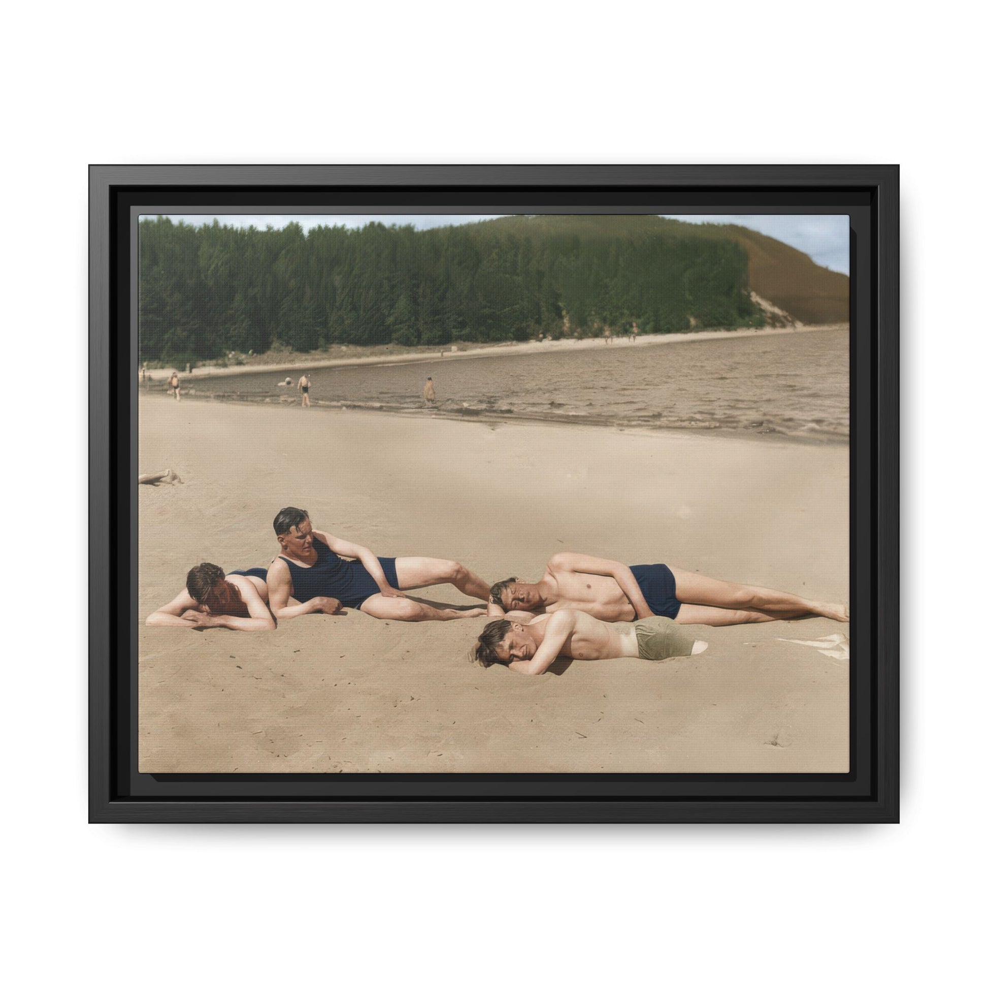 Framed vintage canvas wall art showing four bathers reclining on a lakeside beach 
