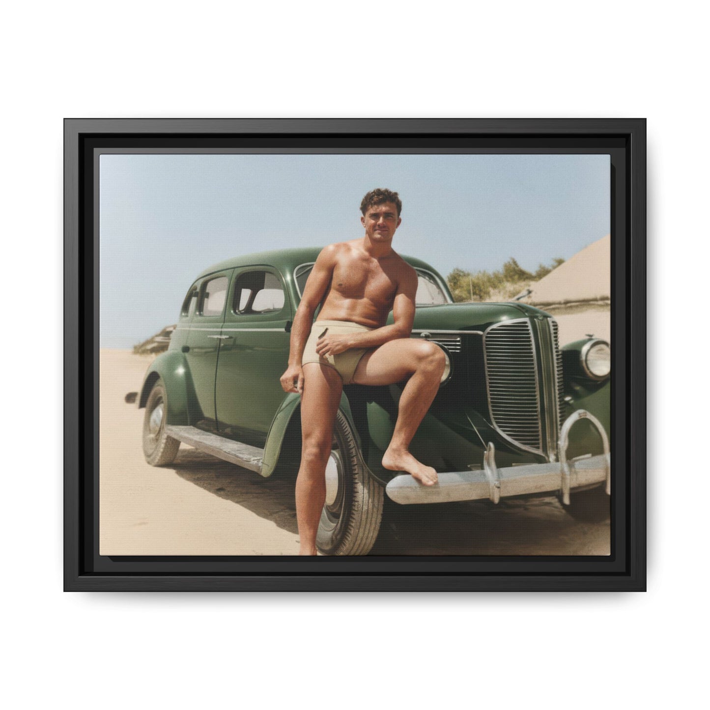 Man posed beside vintage automobile on beach in early 20th-century photograph 