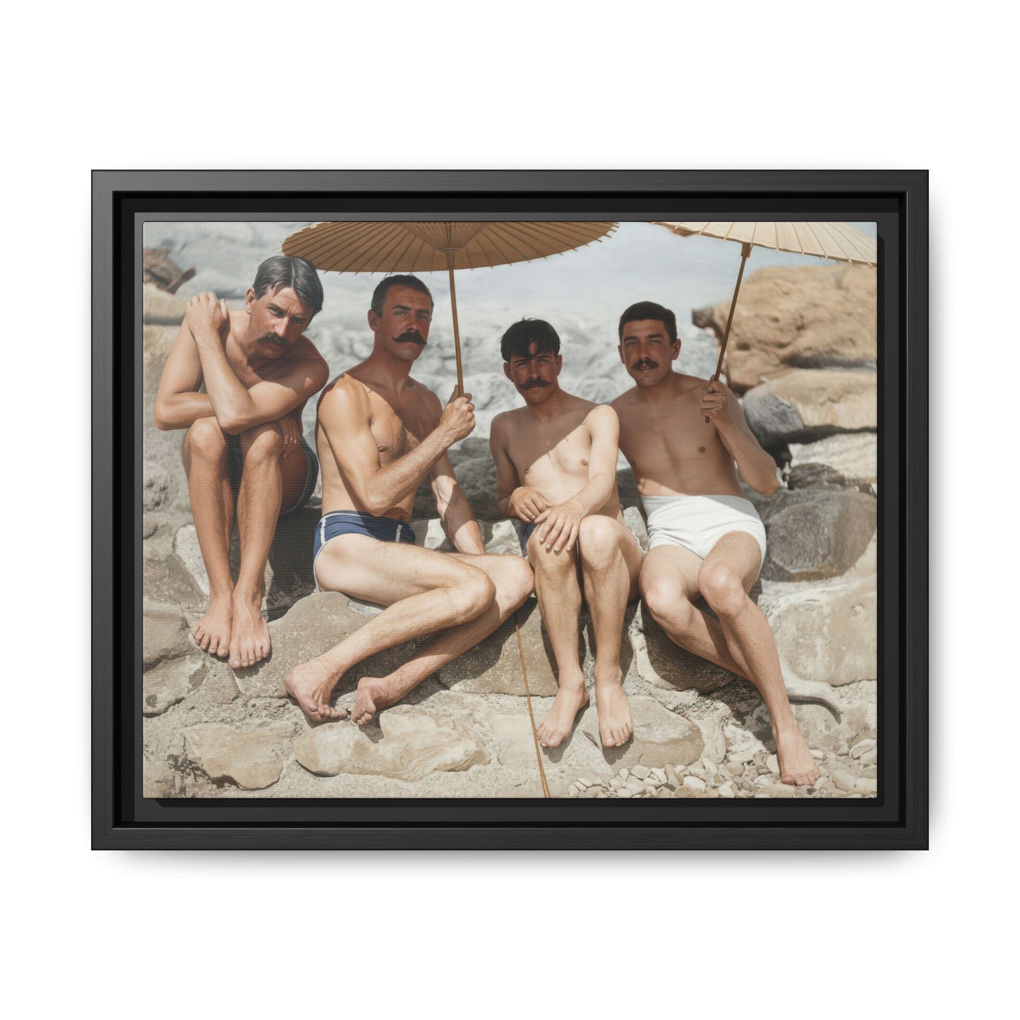 Framed vintage canvas wall art showing four bathers seated on a rocky shore beneath parasols 