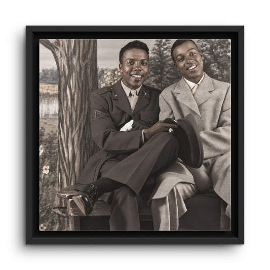 Vintage portrait of two smiling Black men seated together, one in a dark military-style uniform and the other in a light suit, reproduced as framed canvas art.