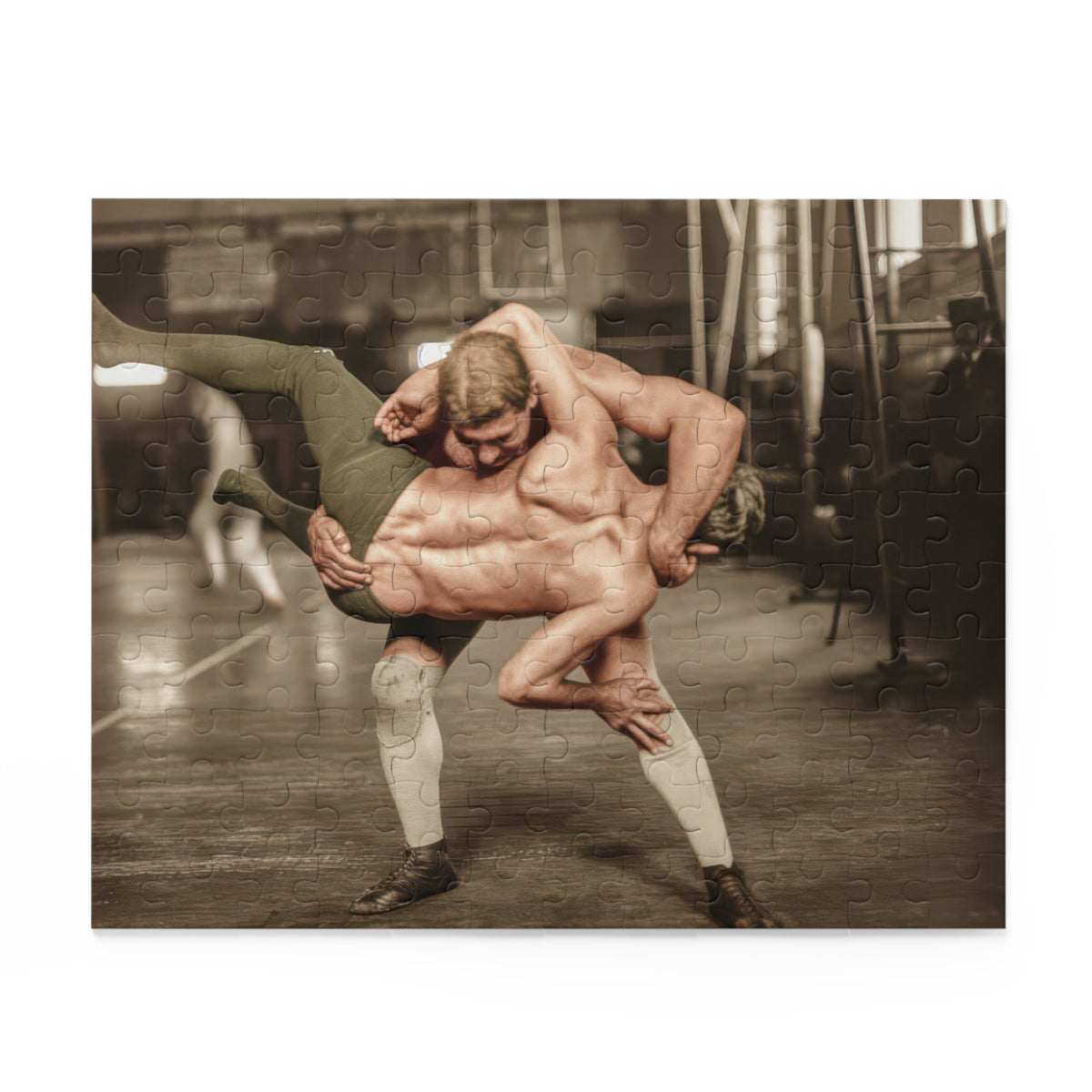 Colorized historical photograph of two wrestlers in a lifting hold on a wooden gymnasium floor, with tall windows and hanging apparatus behind them.