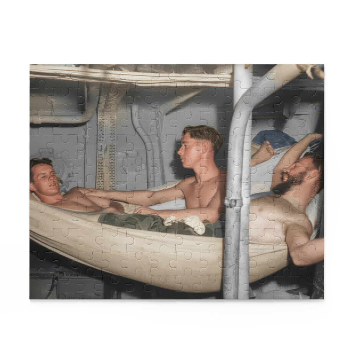 Artwork for a vintage hammock jigsaw puzzle showing reclining men and a central seated figure among pale canvas hammocks, exposed pipes, and metal panels.