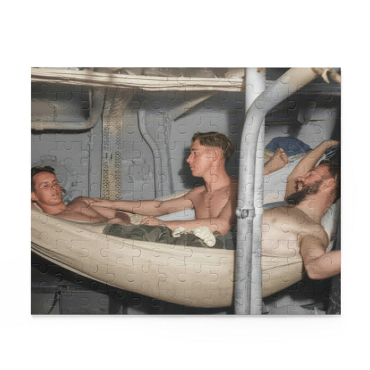 Artwork for a vintage hammock jigsaw puzzle showing reclining men and a central seated figure among pale canvas hammocks, exposed pipes, and metal panels.