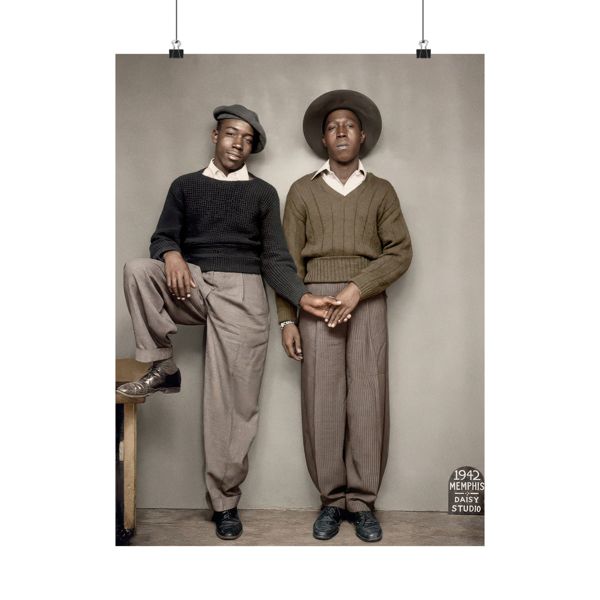 Two African American men in sweaters, tailored trousers, and hats stand together with touching hands in a Memphis studio, 1942.