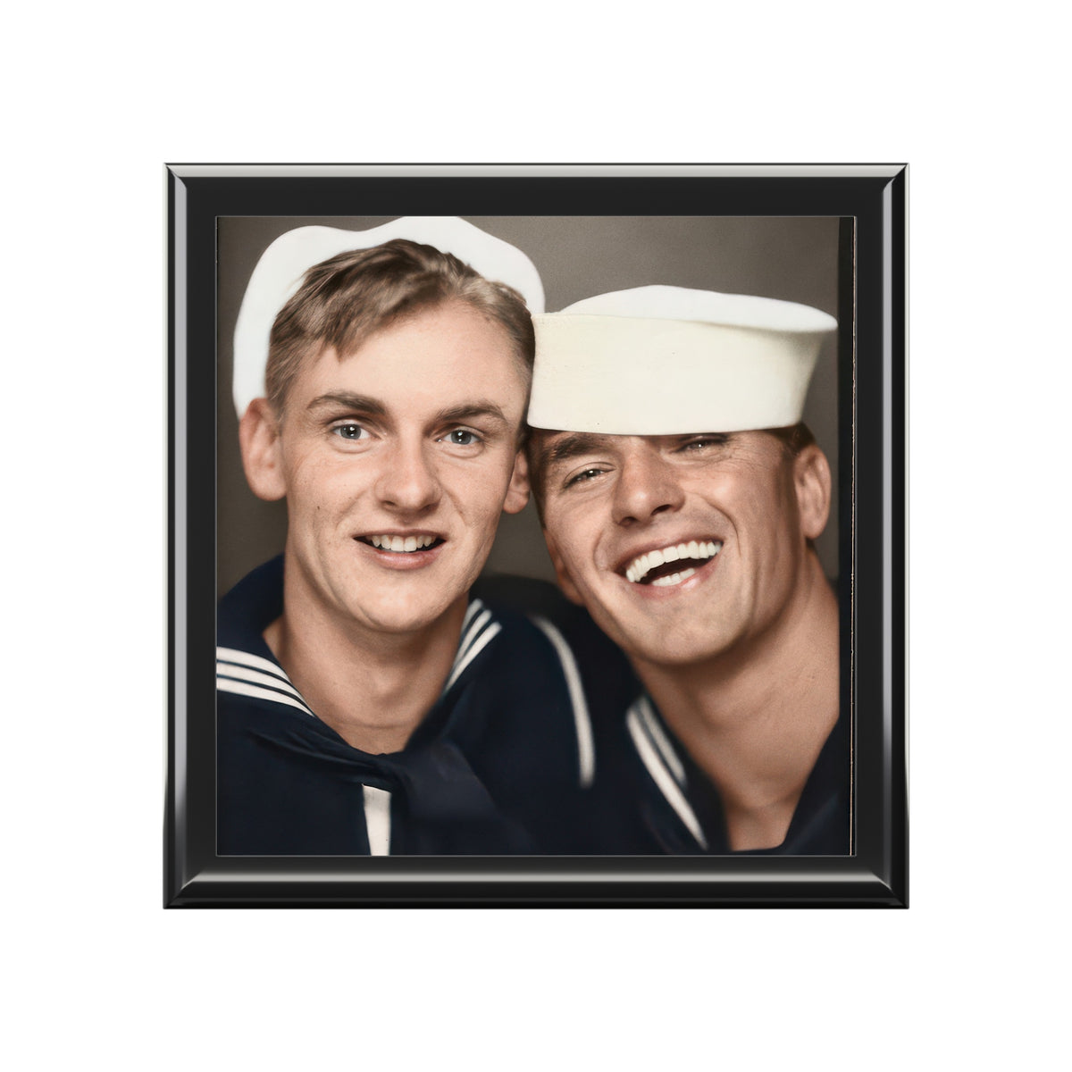 closed-box front view: Closed varnished wooden keepsake box with glossy ceramic tile lid showing a colorized photobooth portrait of two smiling sailors.