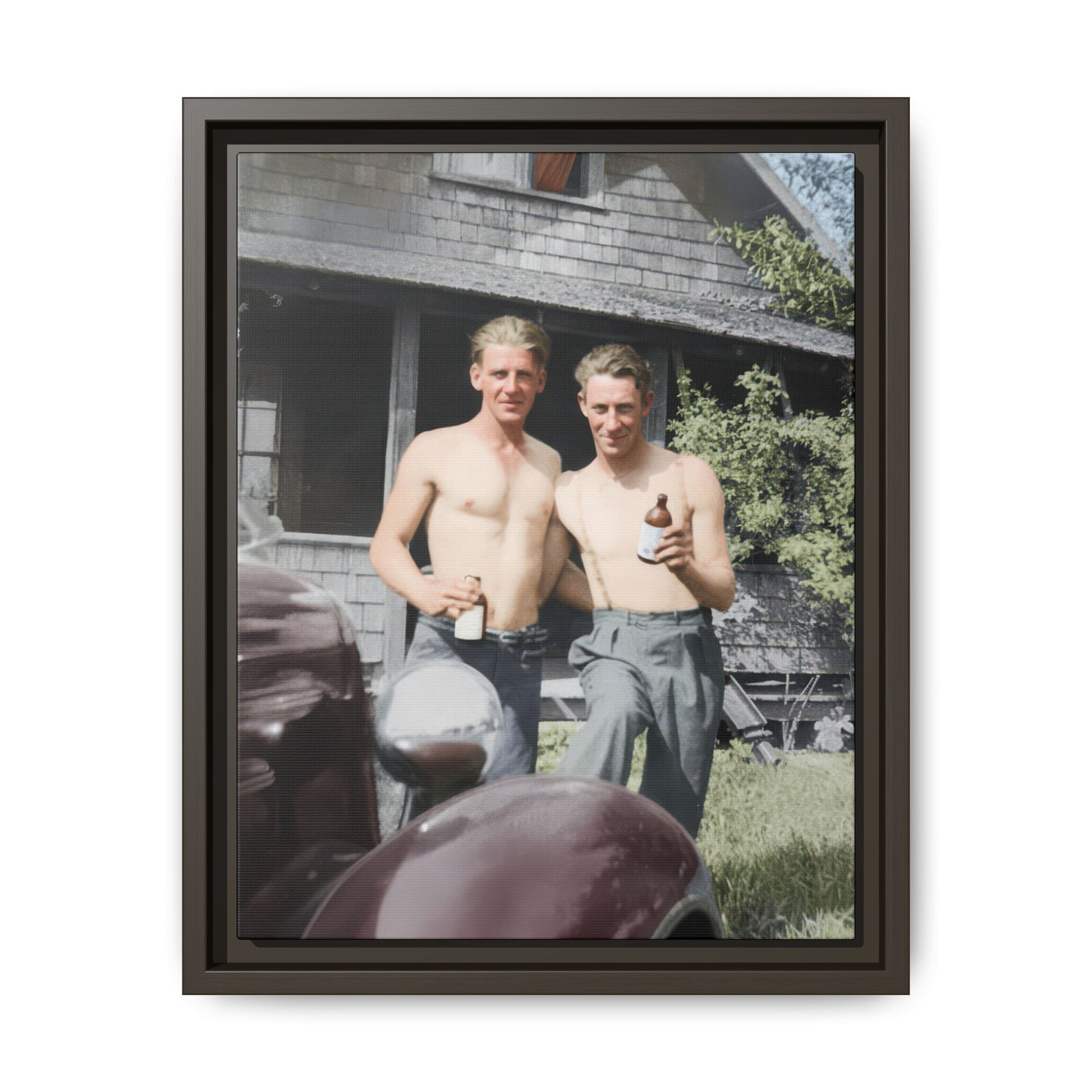 Mid-century historical photograph with shirtless figures holding bottles outdoors