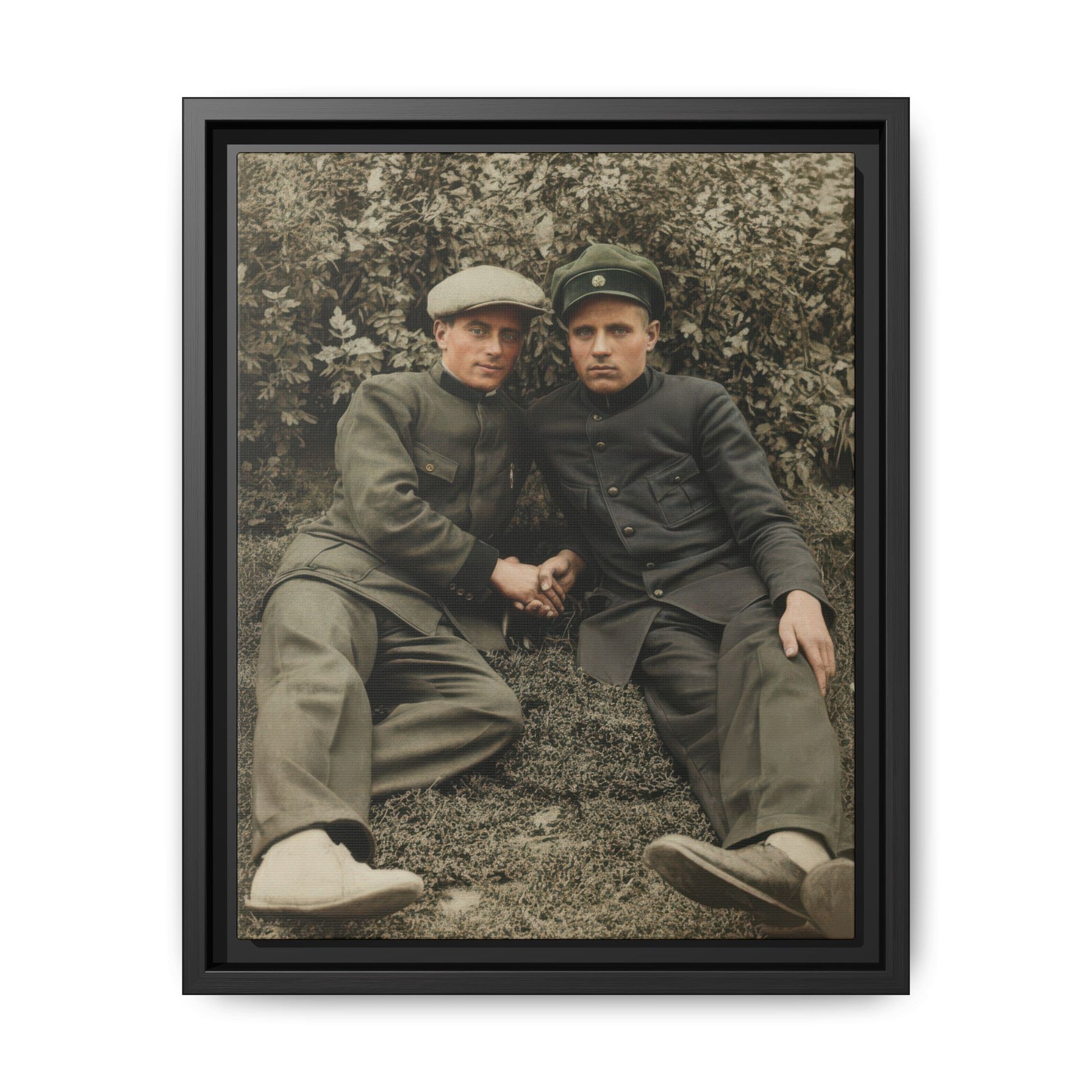Vintage outdoor portrait of two companions in military-style uniforms seated on grass