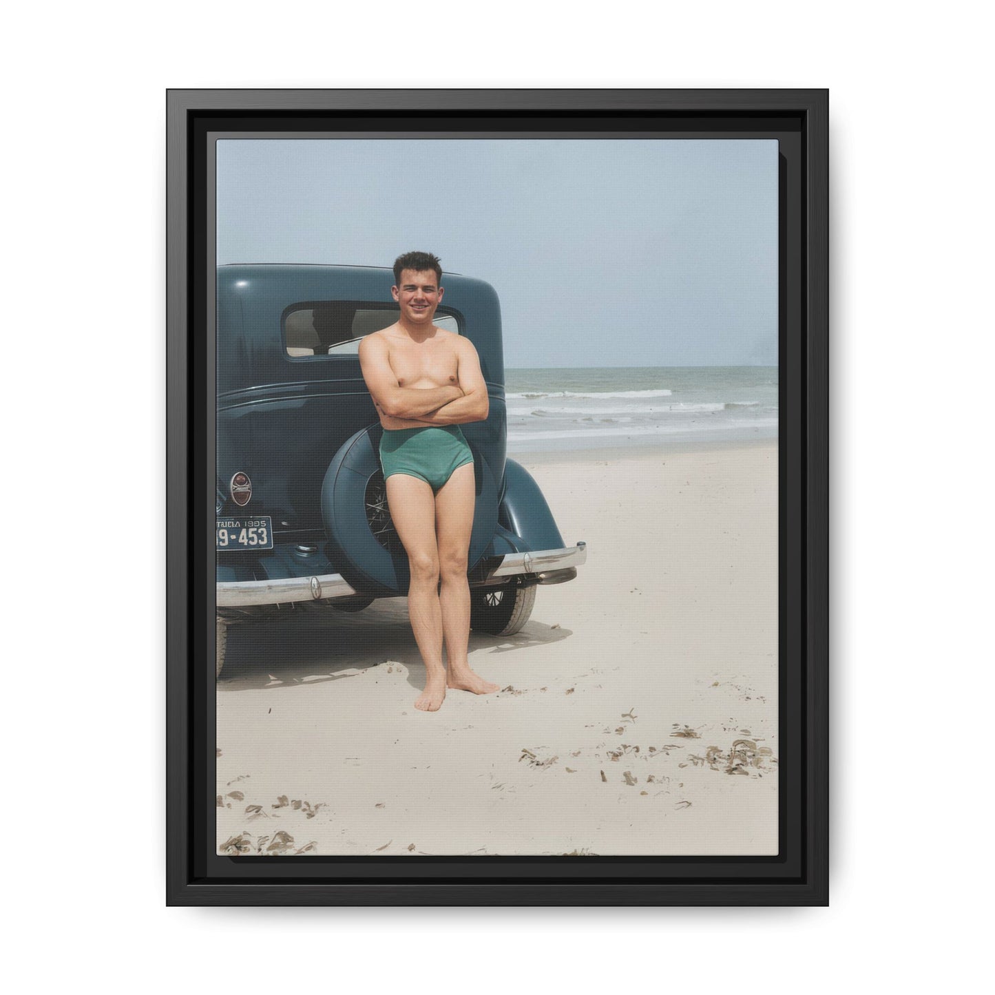 Restored vintage photograph of a man in swim trunks standing beside an automobile on a beach 