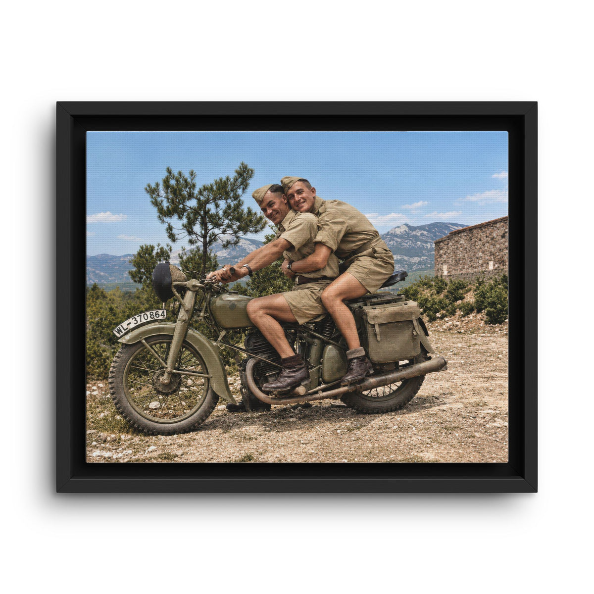 Paire 166 historical photograph of two uniformed men seated on a military motorcycle along a rocky mountain road.