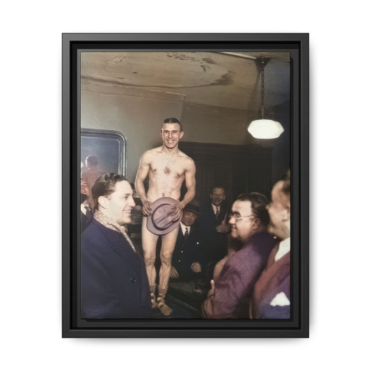Restored colorized photograph of an adult male entertainer holding a hat over his lower body, surrounded by suited men indoors.