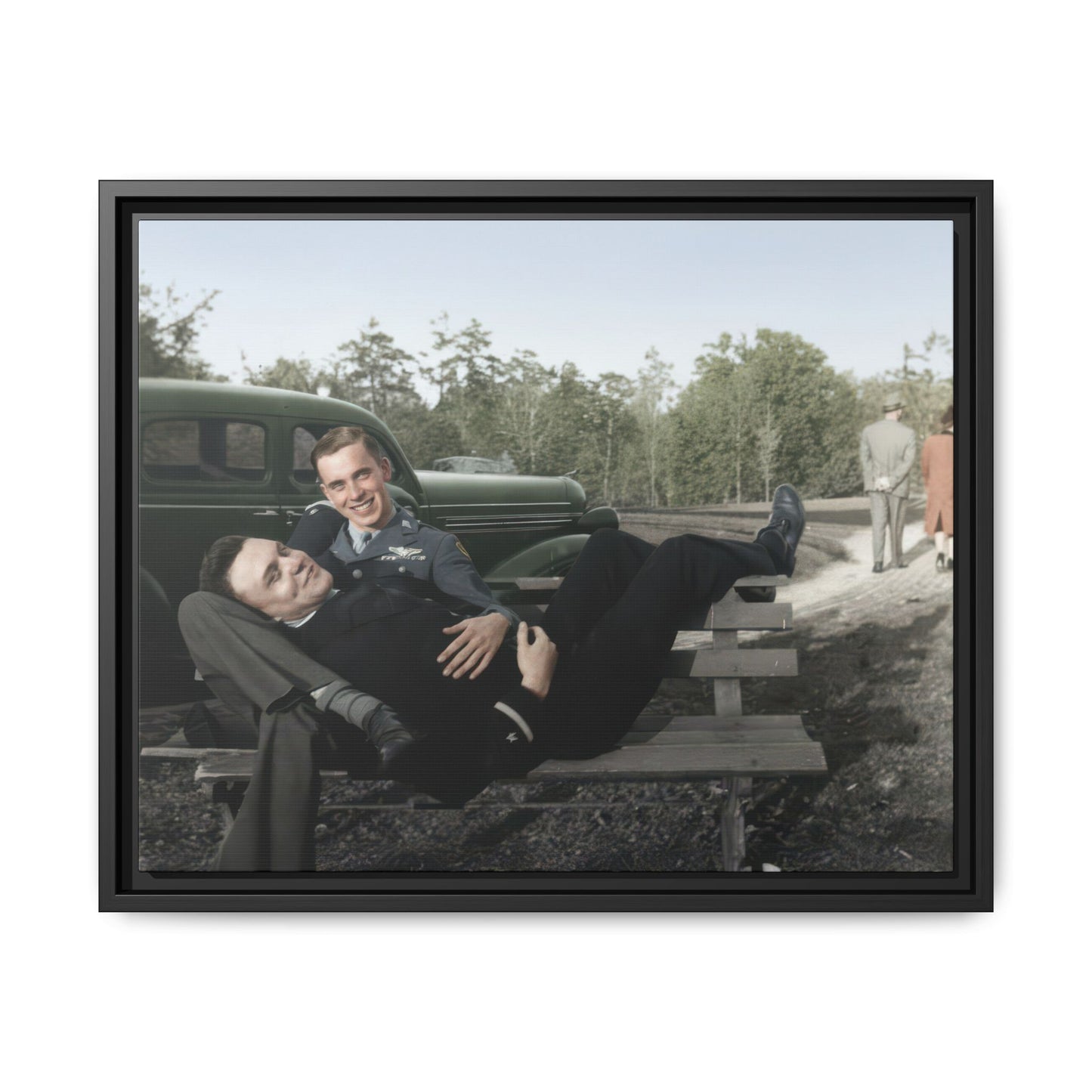 Mid-century historical photograph with reclining figure and uniformed companion outdoors