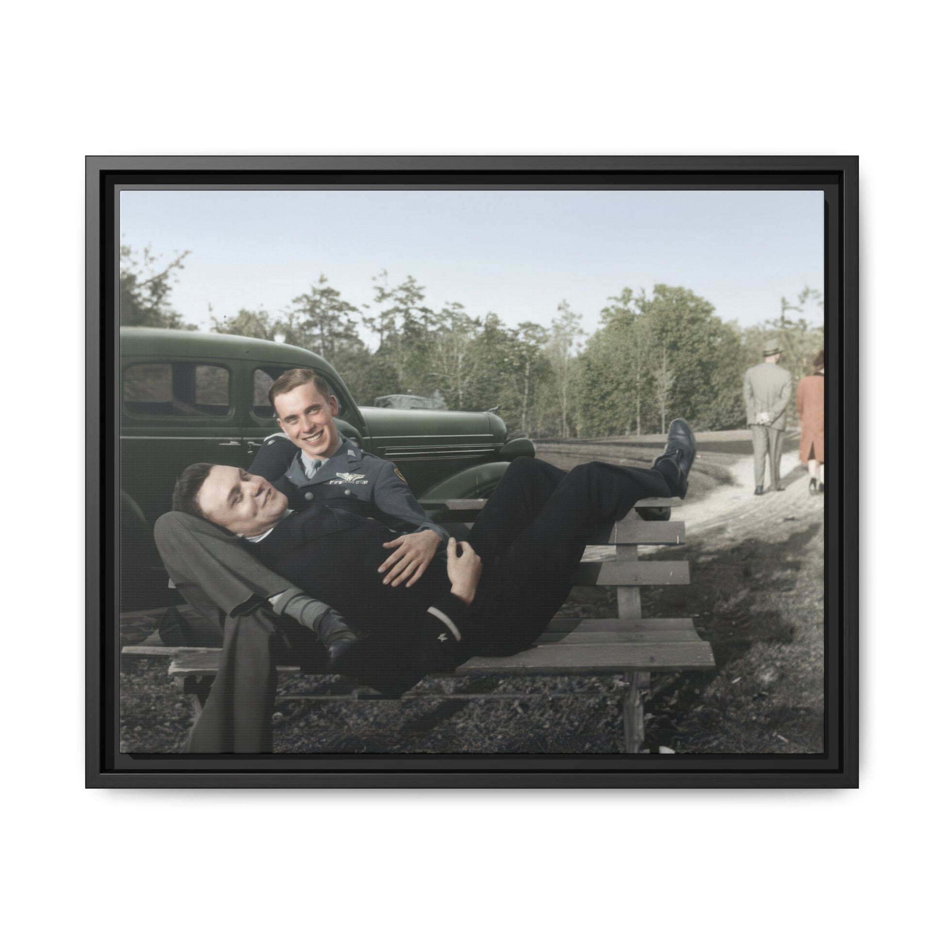 Mid-century historical photograph with reclining figure and uniformed companion outdoors
