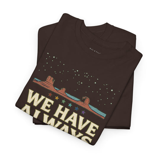 Front of Diné LGBTQ+ and Two-Spirit Pride T-shirt reading We Have Always Been Here beneath a star-filled desert horizon
