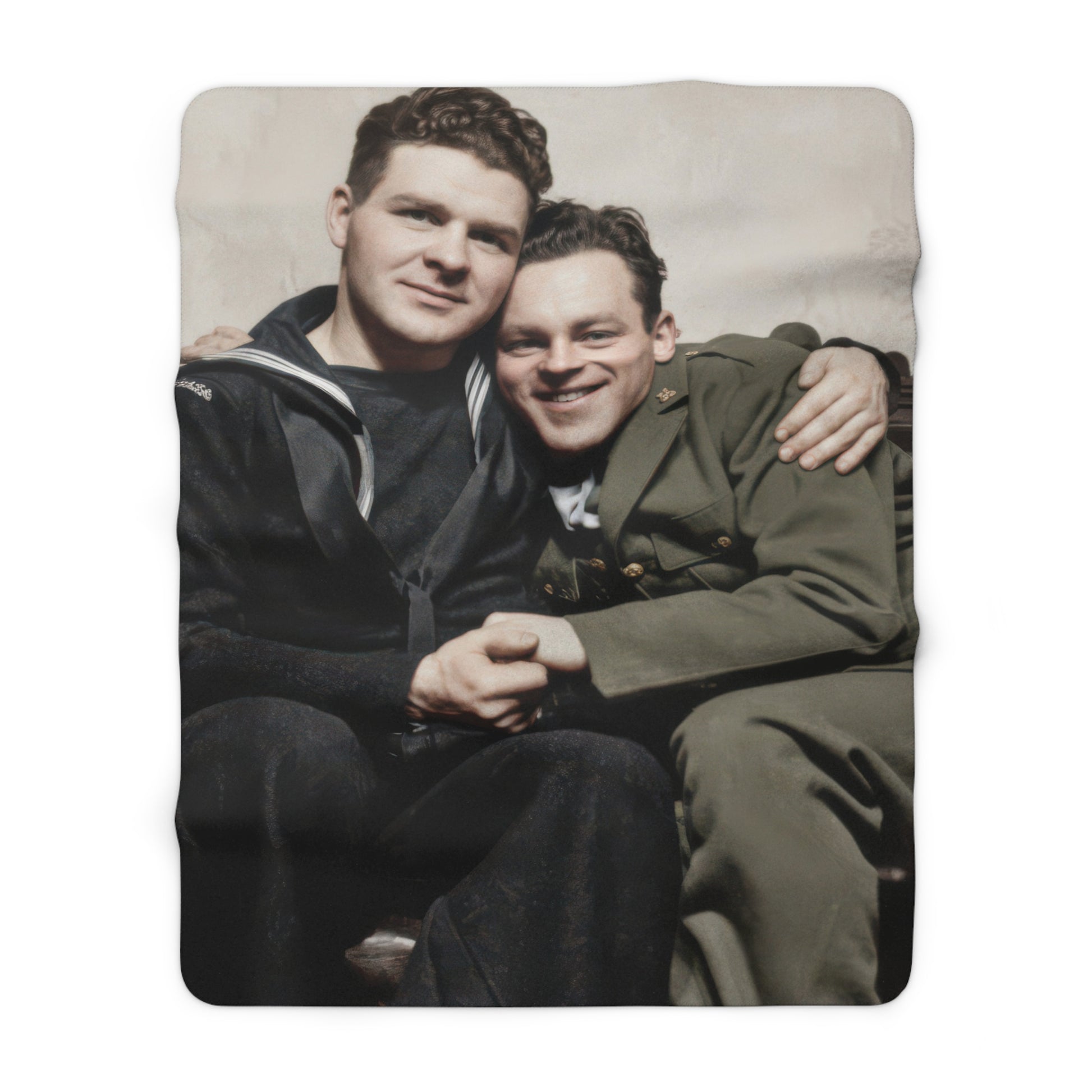 Cozy fleece throw with vintage sailor and soldier portrait on a leather sofa 