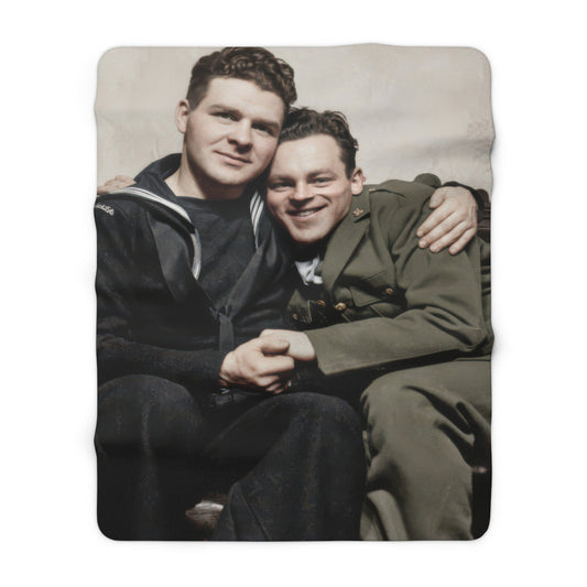 Cozy fleece throw with vintage sailor and soldier portrait on a leather sofa 