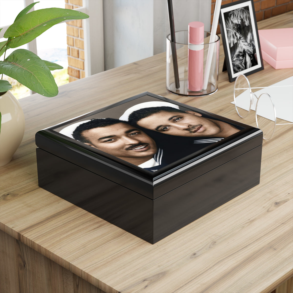 Angled glossy wooden keepsake box with vintage photobooth portrait of two Black sailors wearing white caps and dark uniforms.