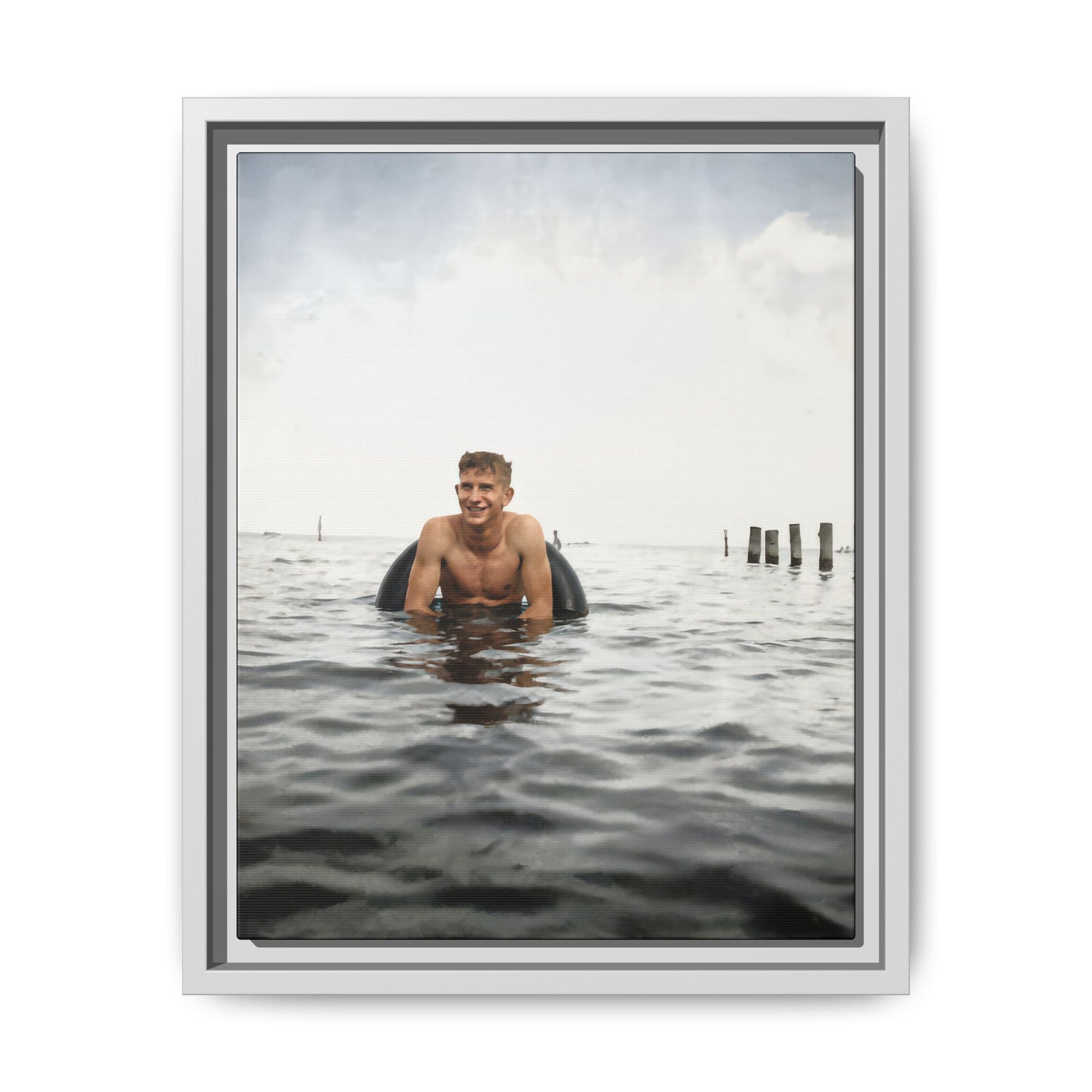 Historical waterfront photograph with figure in water beneath an expansive sky 