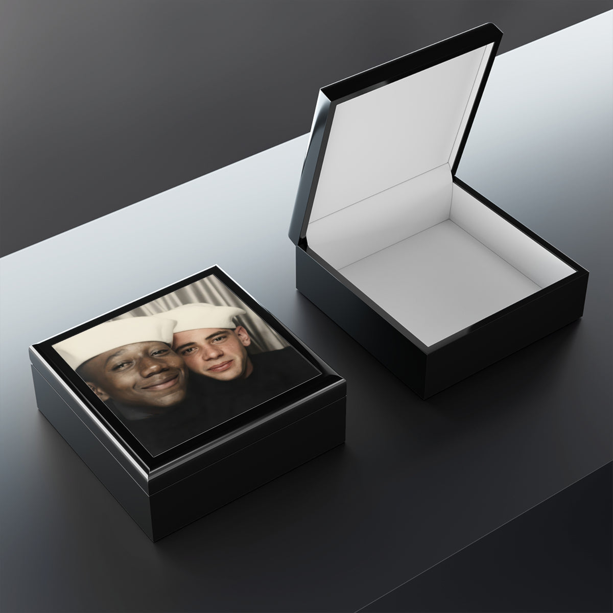 Open wooden keepsake box showing felt lining and a raised lid, with the two Black sailors portrait visible on the lid exterior.