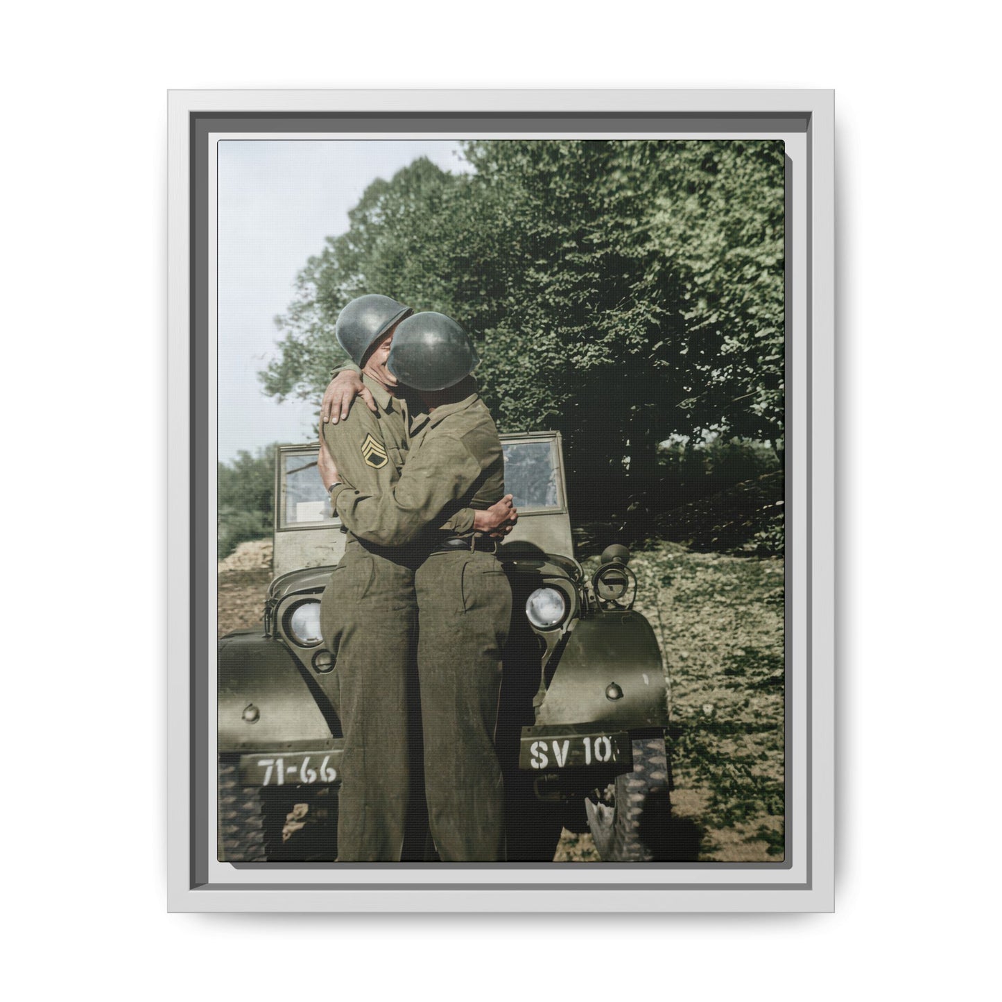 WWII-era vintage photograph of two soldiers embracing beside a military jeep outdoors